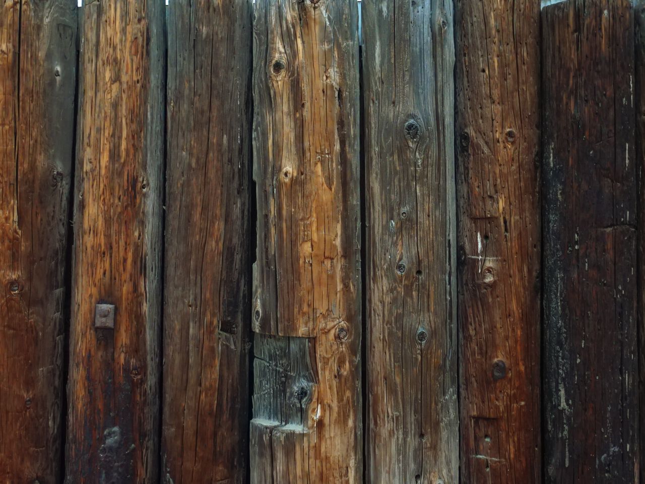 Detailed view of a rustic wooden fence showcasing weathered textures and natural grains.